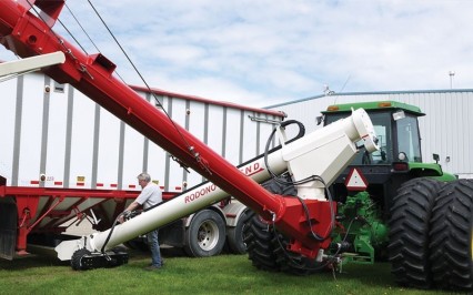 Extends quickly & safely under grain trailer. Both hoppers can be unloaded without moving the truck